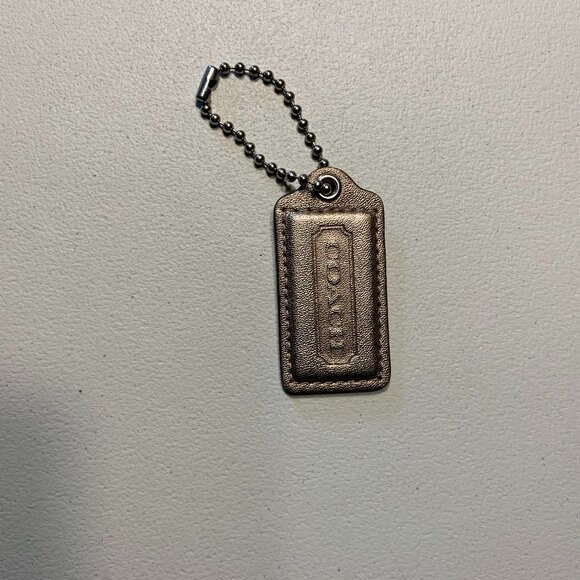 Coach Handbags - Coach Bronze leather tag 2.5" x 1.25"